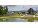 Stunning community pool area with ample seating, lush landscaping, and a modern clubhouse at 101 Rostova Way, Holly Springs, NC 27540