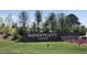 Honeycutt Farm community entrance sign amid beautiful landscaping and vibrant flower beds at 101 Rostova Way, Holly Springs, NC 27540