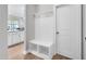 Mudroom entryway features built-in storage bench, coat hooks, and convenient access to an adjacent room at 101 Rostova Way, Holly Springs, NC 27540