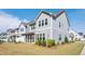 Exterior view of townhomes showcasing the landscaping and well-maintained surroundings at 101 Rostova Way, Holly Springs, NC 27540