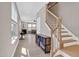 Light-filled foyer with hardwood floors and a staircase leads to the upper level at 101 Rostova Way, Holly Springs, NC 27540