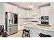 Modern kitchen featuring white cabinets, granite countertops, stainless steel appliances, and a center island at 101 Rostova Way, Holly Springs, NC 27540