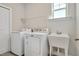 Laundry room featuring a sink, washing machine, and dryer at 101 Rostova Way, Holly Springs, NC 27540