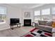 Bright living room features a fireplace, recessed lights and large windows with blinds at 101 Rostova Way, Holly Springs, NC 27540