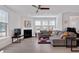 Bright living room features a fireplace, recessed lights and large windows with blinds at 101 Rostova Way, Holly Springs, NC 27540
