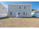 Back exterior featuring a sliding glass door, yard, and siding at 103 Norris Creek Dr, Clayton, NC 27527