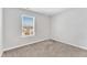 Cozy bedroom featuring neutral tones, carpeting, and a large window providing ample natural light at 103 Norris Creek Dr, Clayton, NC 27527