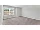 Neutral-toned bedroom with plush carpeting, a large window, and ample natural light at 103 Norris Creek Dr, Clayton, NC 27527