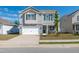 Charming two-story home with stone accents, a well-maintained lawn, and a two-car garage at 103 Norris Creek Dr, Clayton, NC 27527