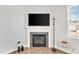 Close-up of the fireplace highlighting the mantle and hearth, with the TV mounted above it at 103 Norris Creek Dr, Clayton, NC 27527
