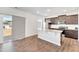 Open-concept kitchen with stainless-steel appliances, dark cabinets, and access to the outdoor patio at 103 Norris Creek Dr, Clayton, NC 27527