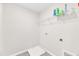 Bright laundry room features wire shelving, tile flooring, and utility connections at 103 Norris Creek Dr, Clayton, NC 27527