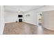 The well-lit living room features wood floors, a fireplace, and sliding glass doors leading to the backyard at 103 Norris Creek Dr, Clayton, NC 27527