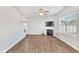 Bright living room showcasing wood floors, a fireplace, and ample natural light from large windows at 103 Norris Creek Dr, Clayton, NC 27527