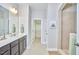 Well-lit bathroom featuring double sinks, modern vanity, and a walk-in shower at 120 Chapel Run Way, Chapel Hill, NC 27517
