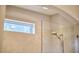 This bathroom has a glass-door shower with beige tile walls and a window allowing for great natural light at 120 Chapel Run Way, Chapel Hill, NC 27517
