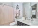 A bathroom featuring a shower with a pink shower curtain, a gray vanity and mirror, and a toilet at 120 Chapel Run Way, Chapel Hill, NC 27517