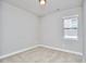 A simple bedroom with neutral carpet, white walls, and a window to let in natural light at 120 Chapel Run Way, Chapel Hill, NC 27517