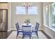 Cozy dining area with blue chairs, bathed in natural light from multiple windows at 120 Chapel Run Way, Chapel Hill, NC 27517