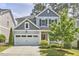 Inviting two-story home with a gray exterior, well-manicured lawn, and an attached two-car garage at 120 Chapel Run Way, Chapel Hill, NC 27517