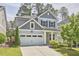 Charming two-story home featuring a two-car garage, well-maintained lawn, and a beautifully landscaped front yard at 120 Chapel Run Way, Chapel Hill, NC 27517