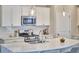 Bright kitchen with stainless steel appliances, a large island with bar seating, and stylish pendant lighting at 120 Chapel Run Way, Chapel Hill, NC 27517
