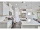 Bright kitchen with stainless steel appliances, a large island with bar seating, and stylish pendant lighting at 120 Chapel Run Way, Chapel Hill, NC 27517