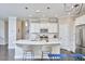 Bright kitchen with stainless steel appliances, a large island with bar seating, and stylish pendant lighting at 120 Chapel Run Way, Chapel Hill, NC 27517