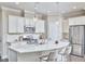 Bright kitchen with stainless steel appliances, a large island with bar seating, and stylish pendant lighting at 120 Chapel Run Way, Chapel Hill, NC 27517