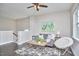 Cozy living room with a comfortable sofa, modern rug, and a ceiling fan at 120 Chapel Run Way, Chapel Hill, NC 27517