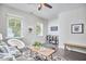 Bright living area with a cozy chair, modern decor, and large windows offering outdoor views at 120 Chapel Run Way, Chapel Hill, NC 27517