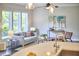 Bright living room with a comfortable couch, modern decor, and abundant natural light from large windows at 120 Chapel Run Way, Chapel Hill, NC 27517