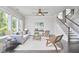 Bright living room with hardwood floors, large windows, and a staircase, creating a welcoming atmosphere at 120 Chapel Run Way, Chapel Hill, NC 27517