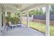 Covered patio with elegant seating area, fan, view of the backyard, and lush landscaping at 120 Chapel Run Way, Chapel Hill, NC 27517