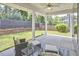 Covered patio with elegant seating area, fan, view of the backyard, and lush landscaping, perfect for outdoor relaxation at 120 Chapel Run Way, Chapel Hill, NC 27517