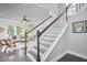 Elegant staircase featuring wood treads, white risers, and decorative railings leading to the upper level at 120 Chapel Run Way, Chapel Hill, NC 27517