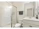 Well-lit bathroom with a glass-enclosed shower, white sink vanity, and a mirror at 121 Martingale Dr, Holly Springs, NC 27540