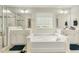 Bright primary bath featuring double vanities, soaking tub, and glass enclosed shower at 121 Martingale Dr, Holly Springs, NC 27540