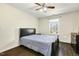 The bedroom features dark wood floors, a ceiling fan, and a window at 121 Martingale Dr, Holly Springs, NC 27540