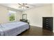 The bedroom features dark wood floors, a ceiling fan, and a dresser at 121 Martingale Dr, Holly Springs, NC 27540