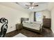 Bedroom with ceiling fan, window, wood flooring, and furnished with bed and dresser at 121 Martingale Dr, Holly Springs, NC 27540