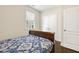 Bedroom featuring a wood bedframe with blue bedding, white trim, and a closet with double doors at 121 Martingale Dr, Holly Springs, NC 27540