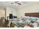 Large bedroom with ceiling fan and attached office space, wooden floors and a large bed at 121 Martingale Dr, Holly Springs, NC 27540