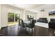 Open concept dining room and living room with a glass table and sliding glass door to the backyard at 121 Martingale Dr, Holly Springs, NC 27540