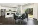 Open-concept dining area with views of the kitchen and glass sliding door to the backyard at 121 Martingale Dr, Holly Springs, NC 27540