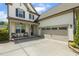 Two-story home featuring a front porch, two-car garage, and driveway at 121 Martingale Dr, Holly Springs, NC 27540
