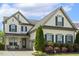 Charming two-story home with inviting front porch and well-manicured landscaping at 121 Martingale Dr, Holly Springs, NC 27540