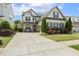 Beautiful two-story home featuring a long driveway and a well maintained lawn at 121 Martingale Dr, Holly Springs, NC 27540