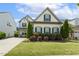 Beautiful two-story home featuring a long driveway and a well maintained lawn at 121 Martingale Dr, Holly Springs, NC 27540
