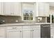 Well lit kitchen featuring white cabinets, stainless steel appliances and a tile backsplash at 121 Martingale Dr, Holly Springs, NC 27540